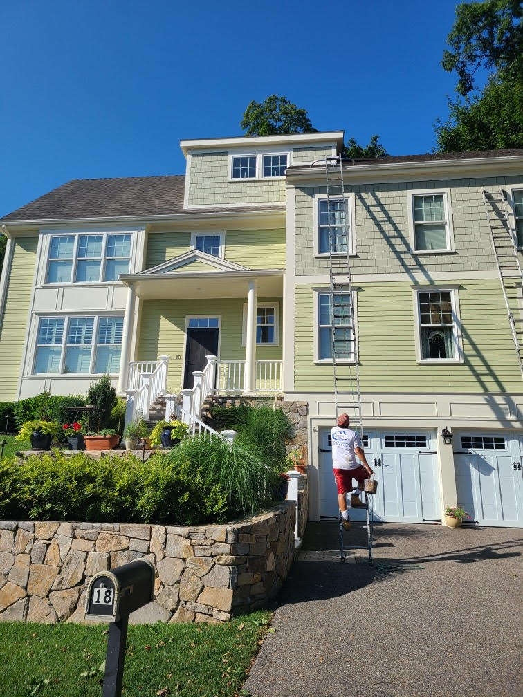 Aura Painting crew painting large green colonial home exterior in Massachusetts