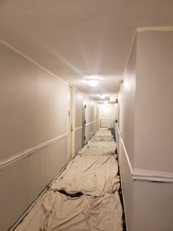 Corridor masked with drop cloths during interior painting