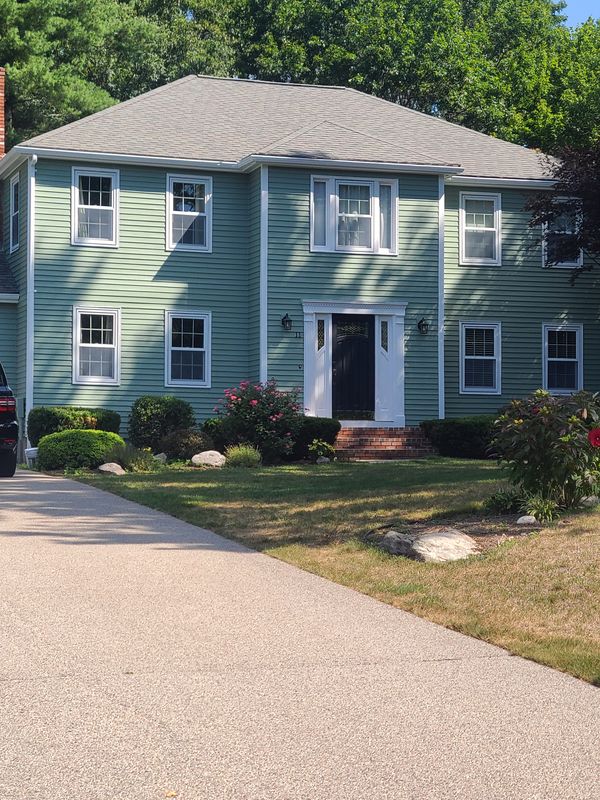 Blue-green colonial exterior after completion