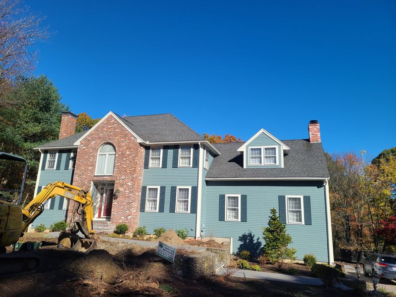 Blue-grey colonial exterior after full repaint