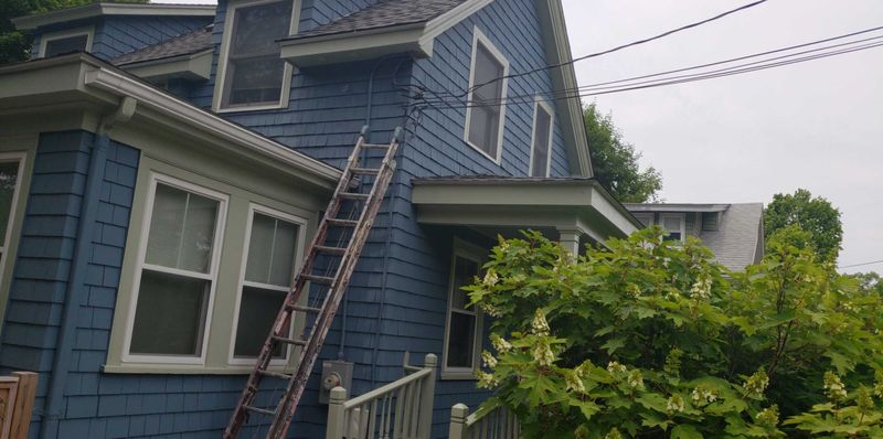 Rear elevation and deck of a repainted shingle house