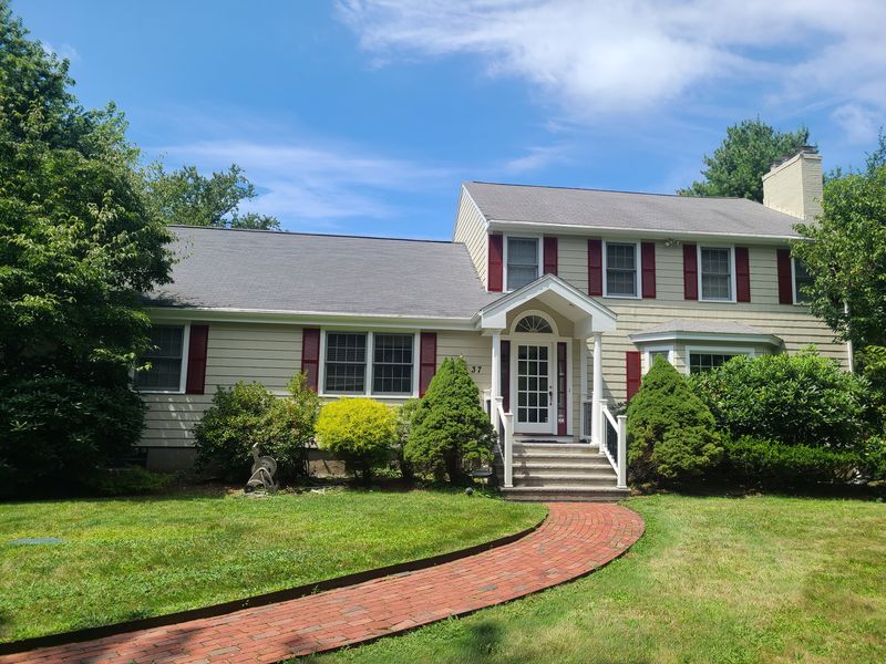 Colonial exterior and brick walkway after completion