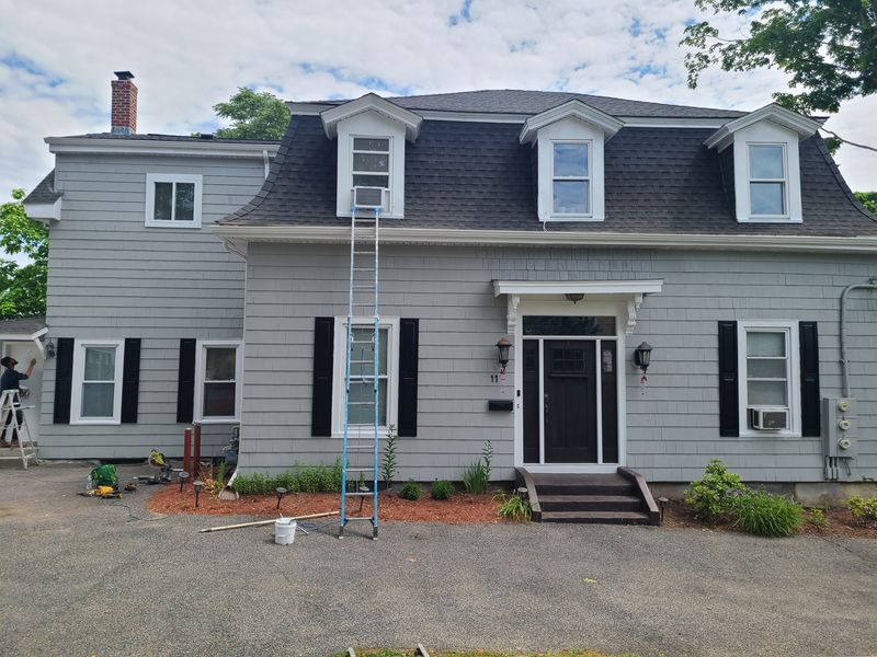 Dutch colonial with black shutters after exterior painting