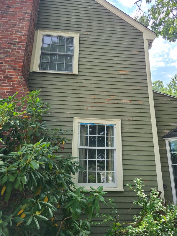 Paint failure across clapboard siding before preparation