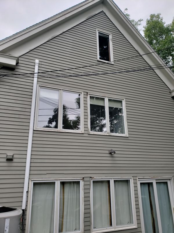 Grey shingle exterior with sage trim after repainting