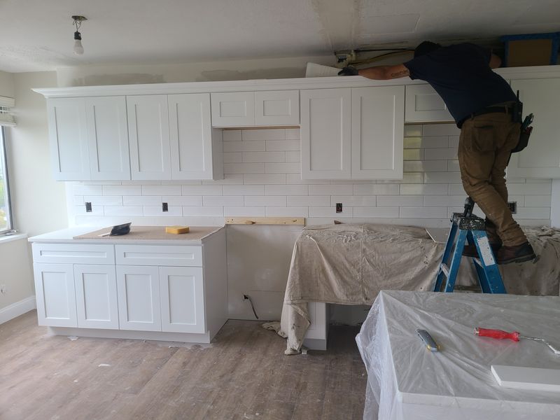 Kitchen cabinets masked and protected during finishing