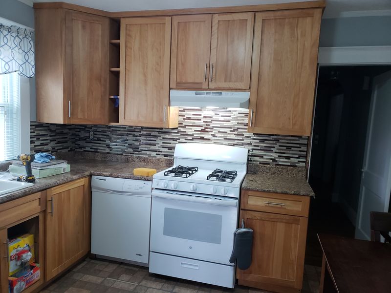Maple shaker kitchen with granite counters and tile backsplash