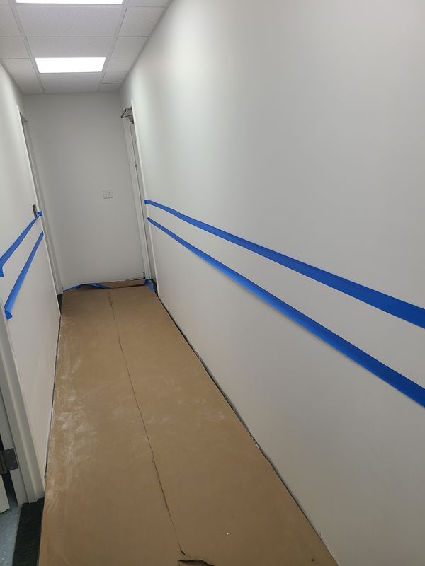 Office corridor masked and taped before painting
