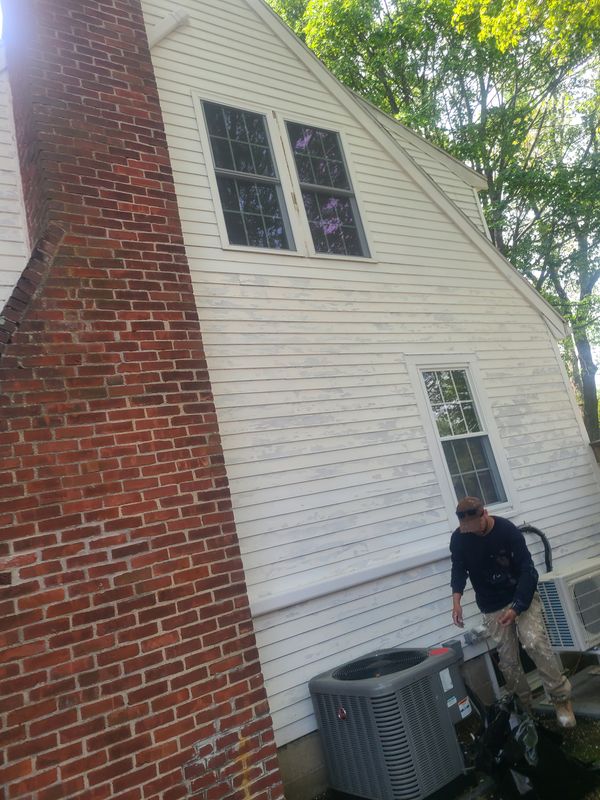 Pressure washing a cape exterior before repainting