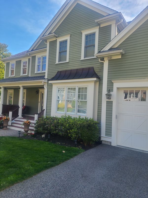 Sage colonial with white portico after exterior painting