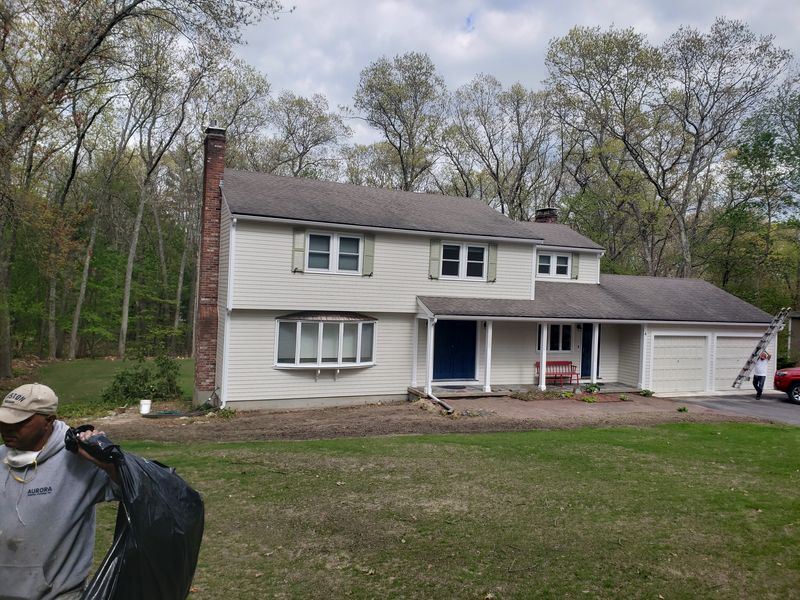 Large shingle-style home after exterior painting