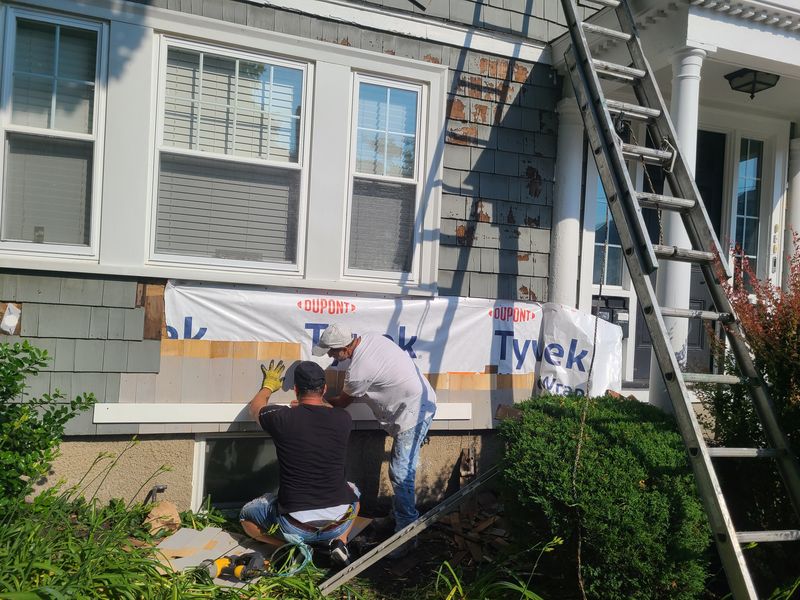 Siding repair with housewrap exposed during exterior work
