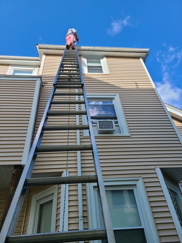 Third-floor exterior painting on a Greater Boston multi-family