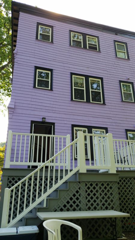 Front porch railings and columns on a repainted three-decker