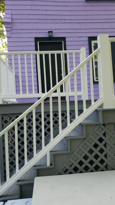 Rear deck stairs and lattice on a three-decker exterior