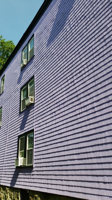 Stacked front porches on a Boston three-decker after repainting