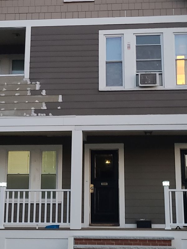 Front porch and entry detail on a finished two-family