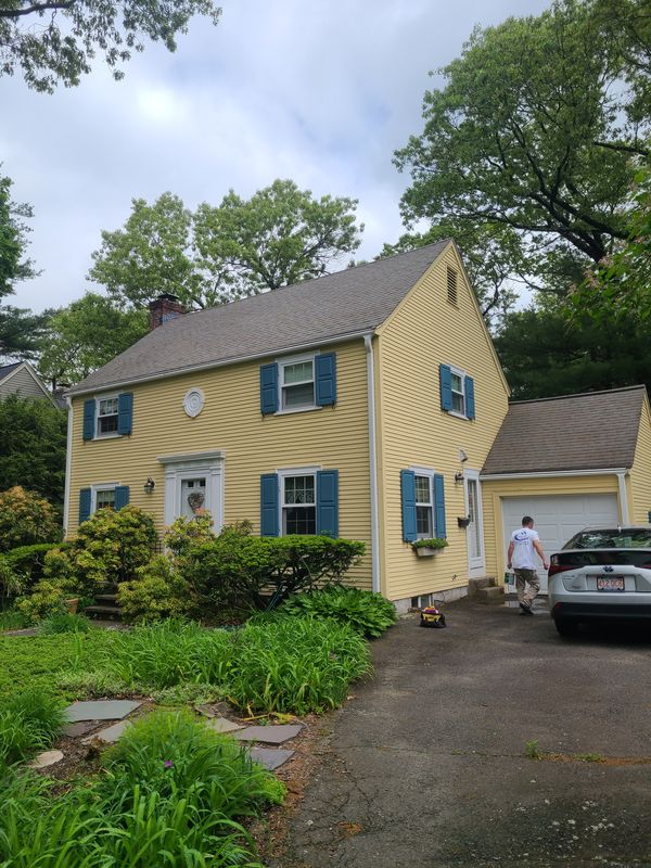 Front elevation of a repainted yellow colonial